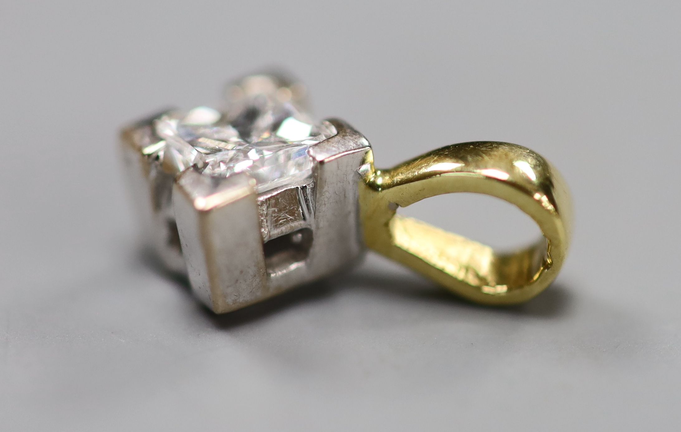 A modern 18ct gold and solitaire princess cut diamond set pendant, overall 7mm, gross 0.9 grams.